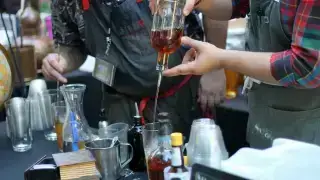 Bartenders preparing alcoholic drinks at a bar, illustrating liquor liability exposure for hospitality businesses