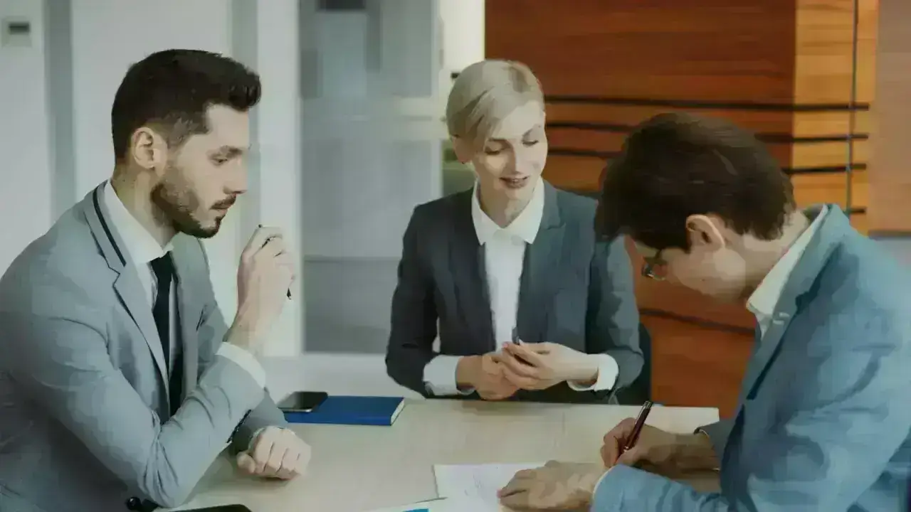 Business professionals reviewing and signing documents, illustrating certificates of insurance