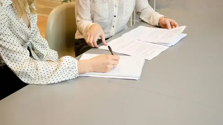 Business professionals reviewing and signing policy documents