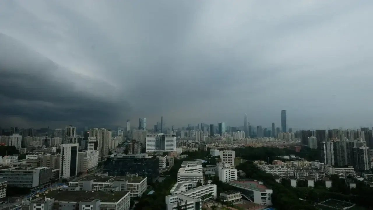 Major city skyline under dark storm clouds illustrating climate and catastrophe exposure