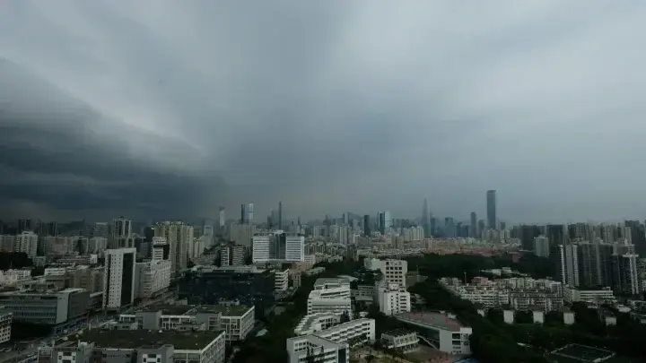 Major city skyline under dark storm clouds illustrating climate and catastrophe exposure