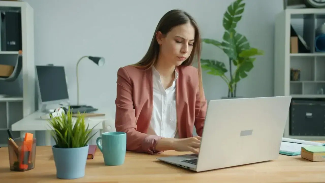 Tired office worker at a laptop, illustrating income risk when illness or injury prevents work