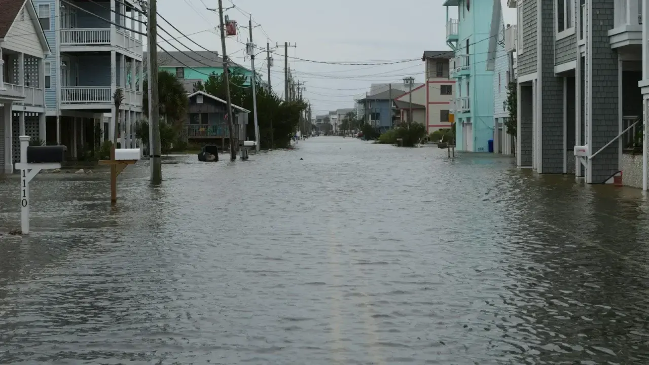 Flood water covering a residential street between homes in the United States