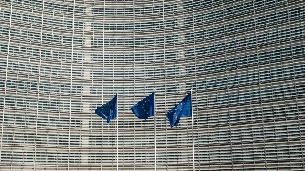 European Union flags outside the European Commission in Brussels, illustrating the EU Insurance Distribution Directive