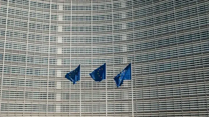 European Union flags outside the European Commission in Brussels, illustrating the EU Insurance Distribution Directive