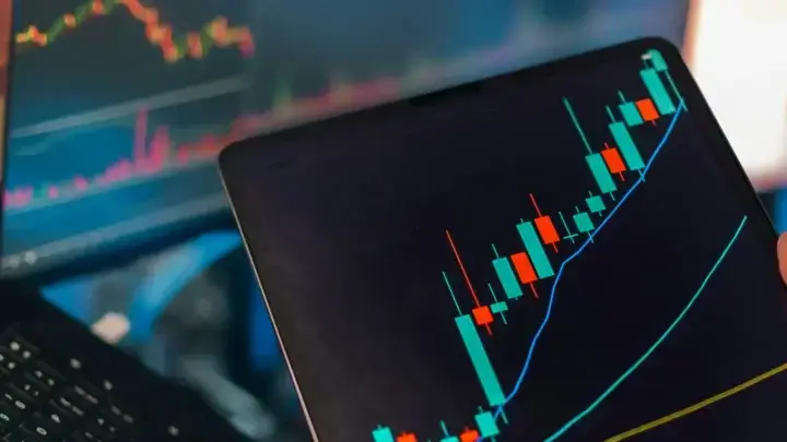 Financial analytics and charts displayed across multiple screens