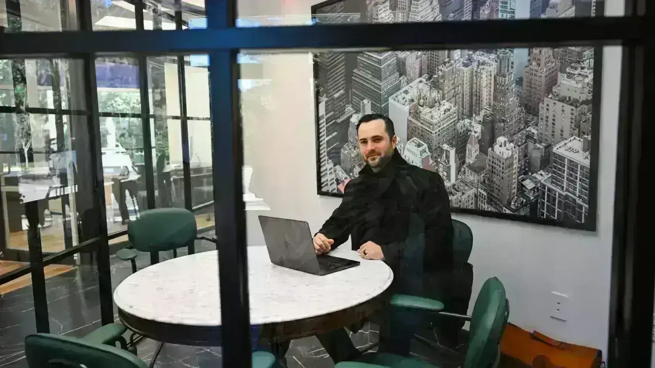 Professional working on a laptop in a meeting room, illustrating errors and omissions insurance