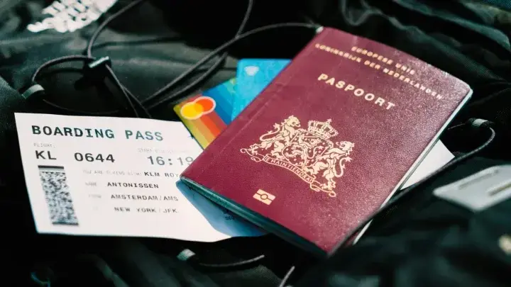 Passport and boarding pass prepared for travel, illustrating Schengen visa travel medical insurance requirements