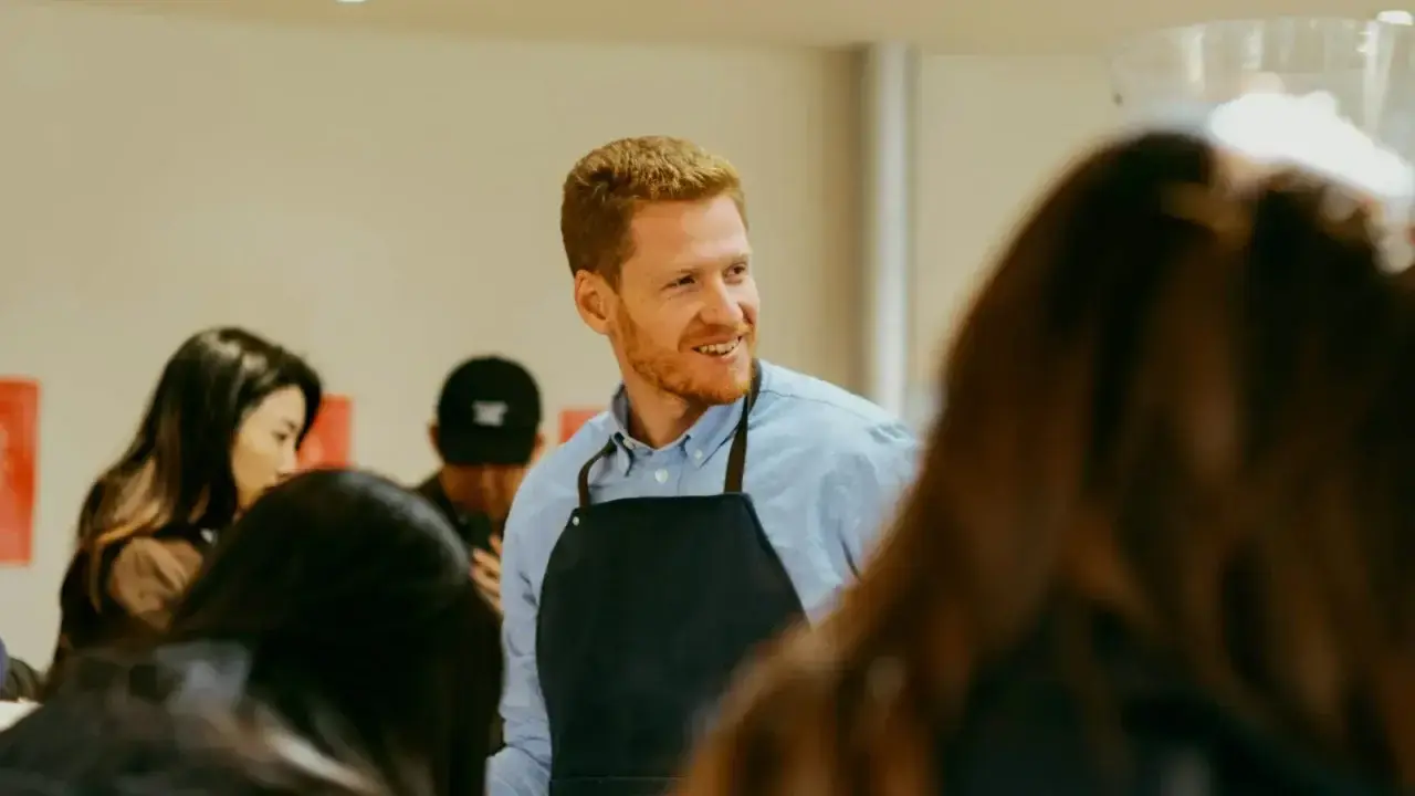 Small business owner serving customers in a shop