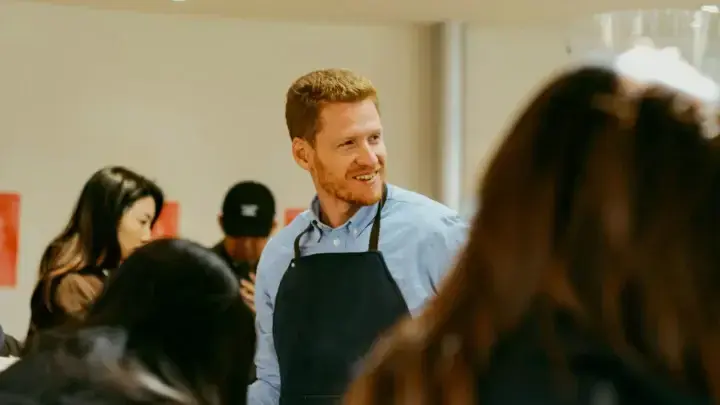 Small business owner serving customers in a shop