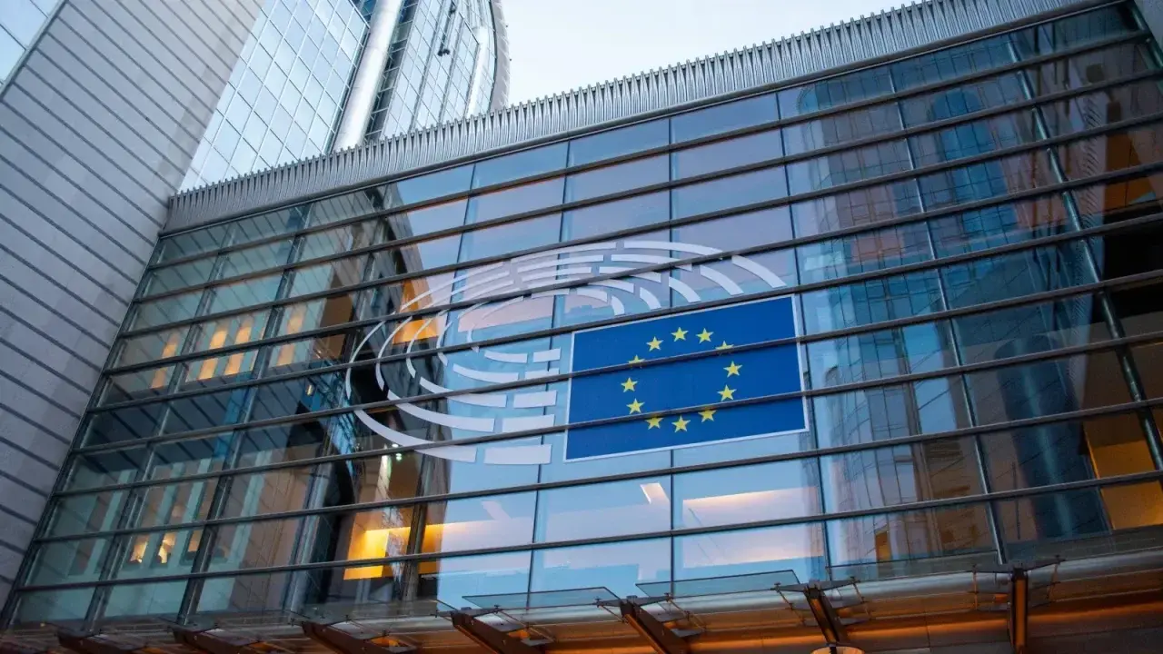 European Union flag reflected on a modern Brussels building, illustrating Solvency II regulation
