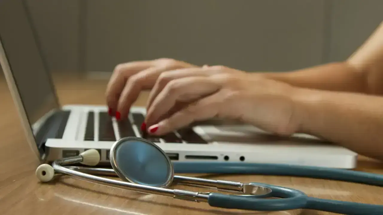 Laptop beside a stethoscope, illustrating Marketplace health insurance enrollment and Special Enrollment Periods