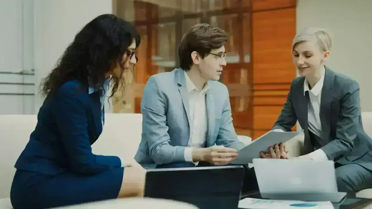 Business professionals reviewing contract documents, illustrating additional insured and certificate requirements