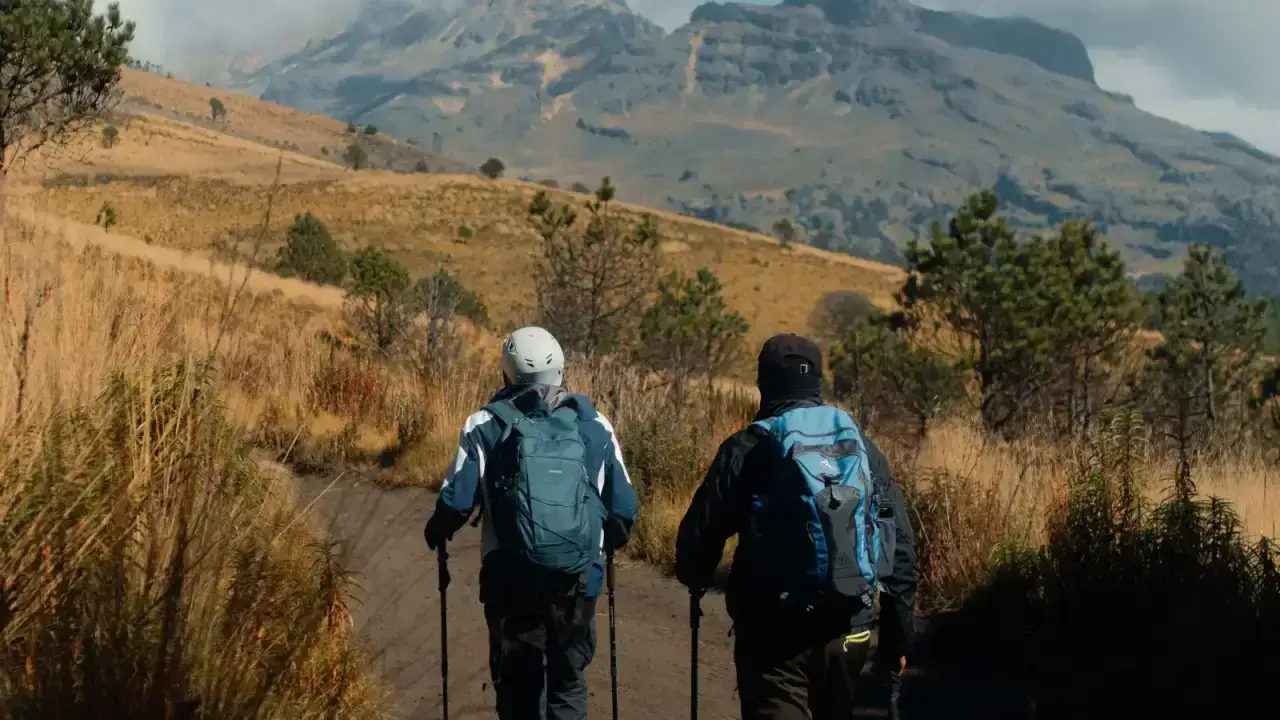 Hiker crossing a mountain landscape for an adventure sports travel insurance guide