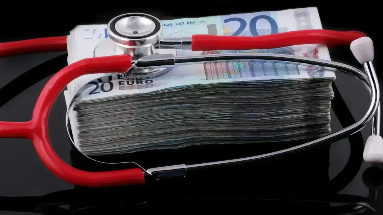 Household paperwork and calculator representing medical bills, allowed amounts and health insurance cost sharing