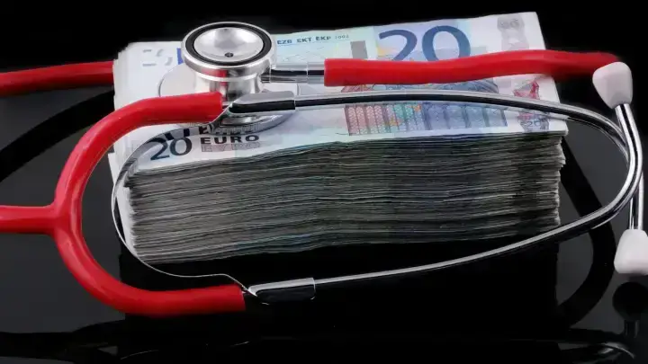 Household paperwork and calculator representing medical bills, allowed amounts and health insurance cost sharing
