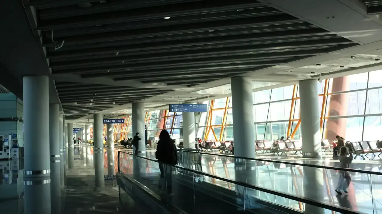 Traveler moving through a modern airport terminal, illustrating annual multi-trip and single-trip travel insurance choices