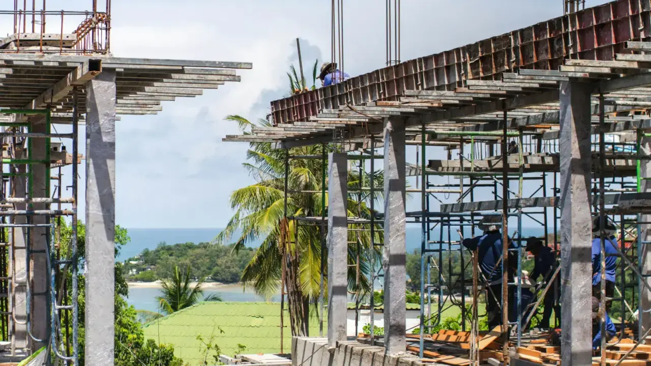 Workers and concrete structure at an active construction site, illustrating builder's risk insurance for projects under construction