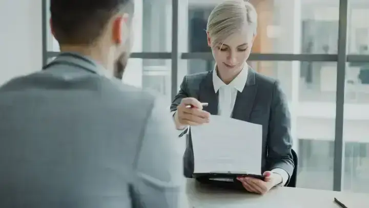Business professionals reviewing a contract at a meeting illustrating commercial general liability insurance limits