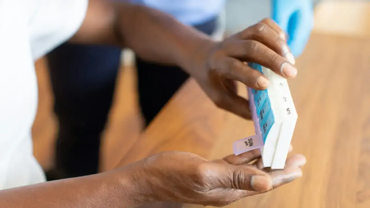 Person holding a health insurance card, illustrating COBRA continuation health coverage after job loss