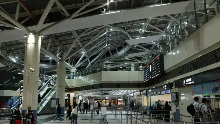Airport terminal with departure information boards, illustrating travel disruption and trip cancellation planning