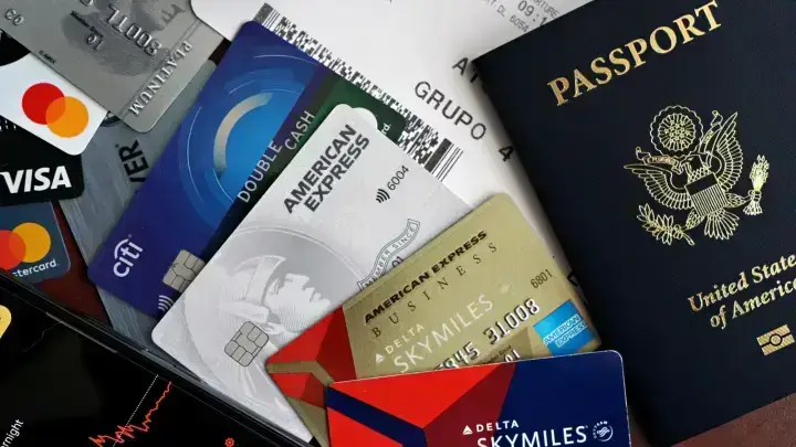 Passport, credit cards and boarding pass arranged as travel essentials illustrating travel insurance benefit comparisons