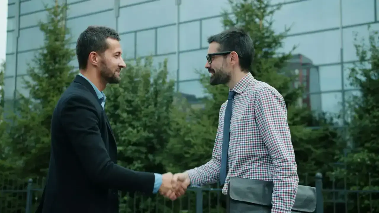 Business professionals shaking hands, illustrating credit for reinsurance and cross-border reinsurance agreements
