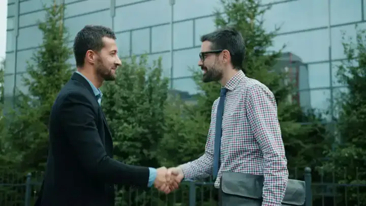 Business professionals shaking hands, illustrating credit for reinsurance and cross-border reinsurance agreements