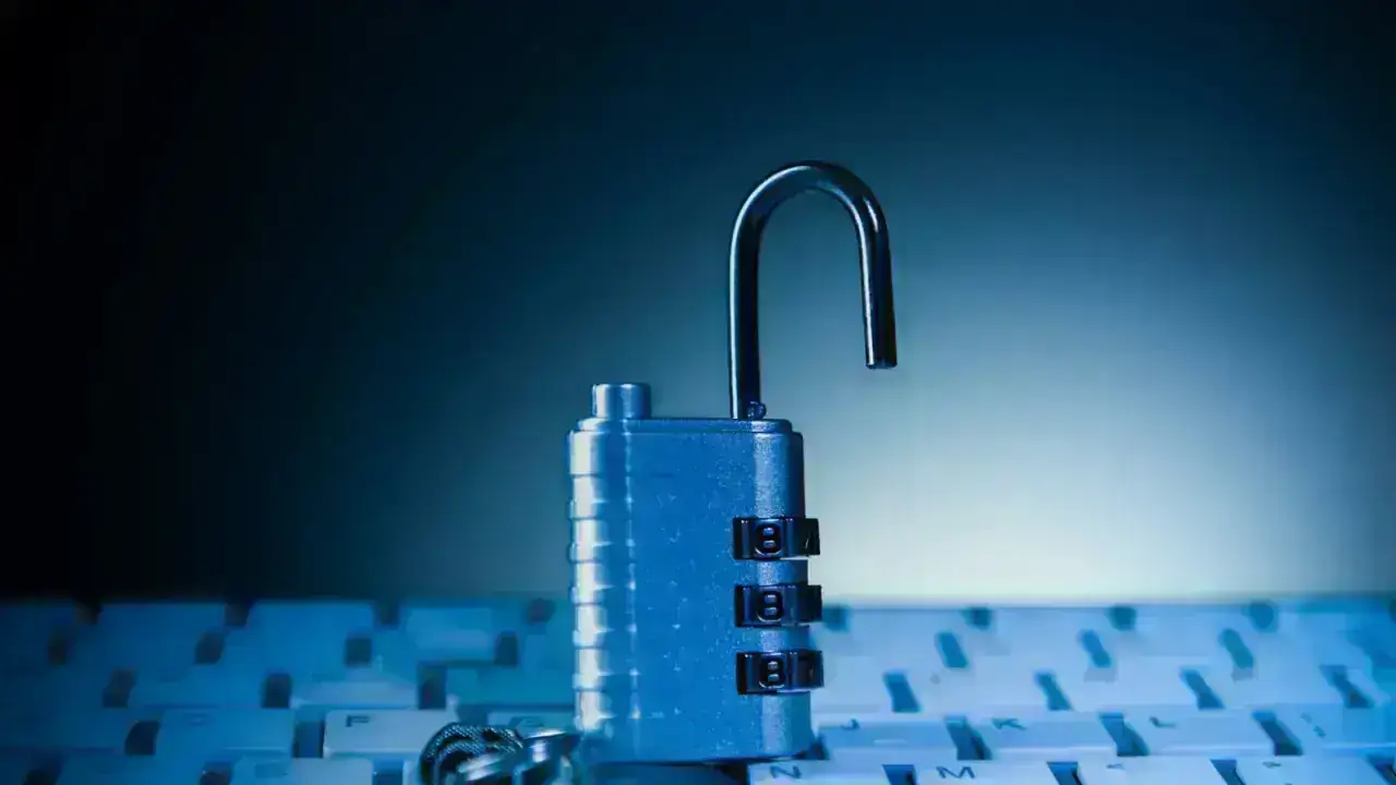 Unlocked padlock on a computer keyboard illustrating cyber insurance timing, prior acts and data-security risk