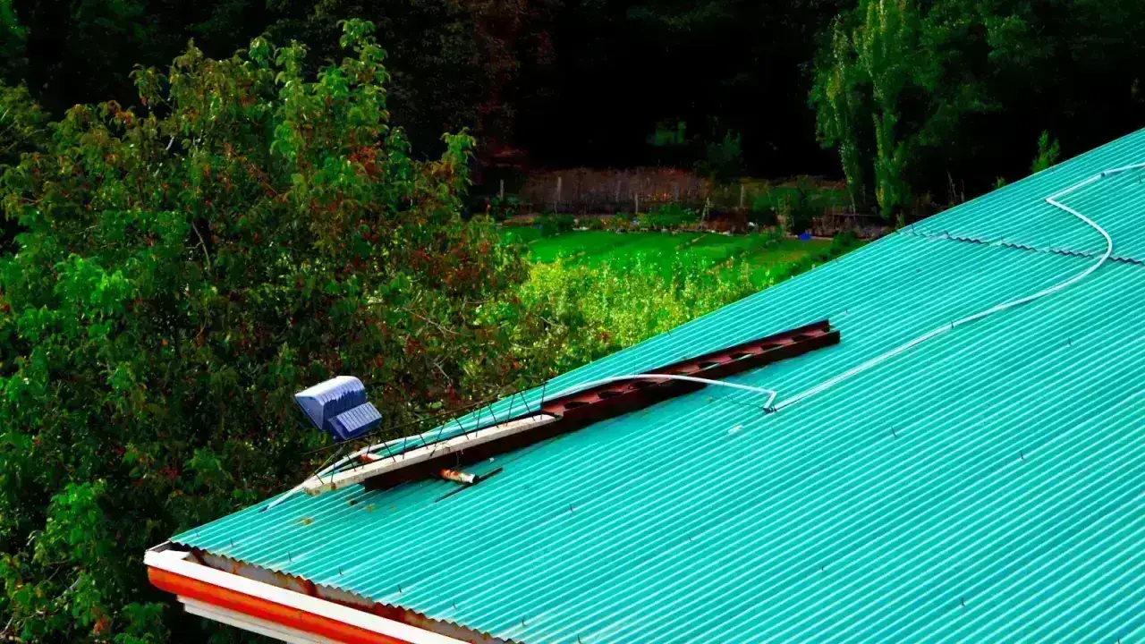 Damaged residential roof illustrating a homeowners insurance roof leak and storm damage claim