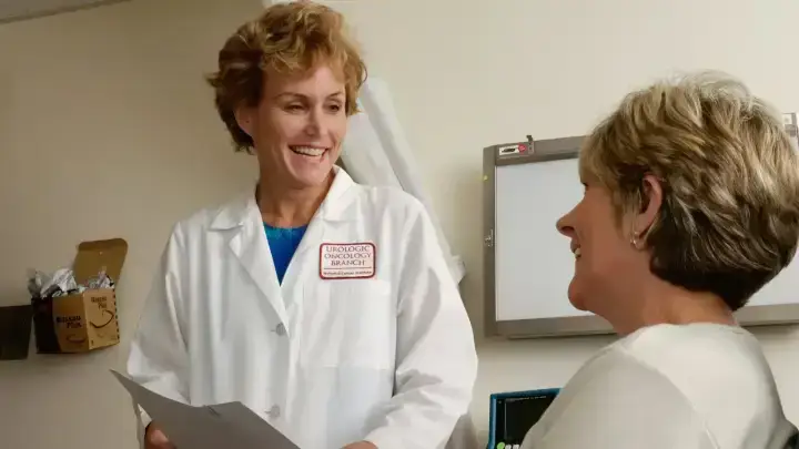 Doctor speaking with a patient in a clinic illustrating urgent care and health insurance choices