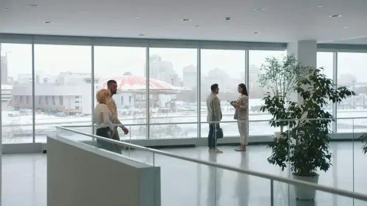 Business colleagues discussing workplace matters in a modern office, illustrating employment practices liability risk