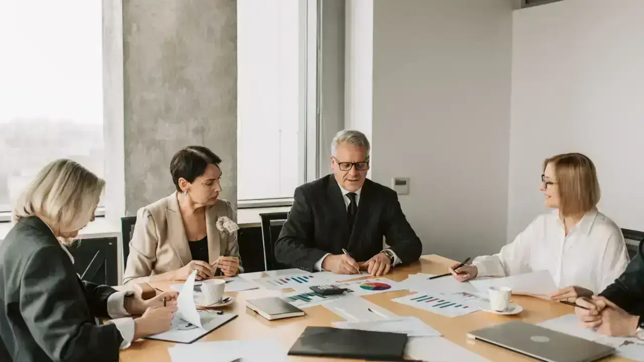 Insurance and finance professionals reviewing risk information illustrating reinsurance follow-the-settlements clauses