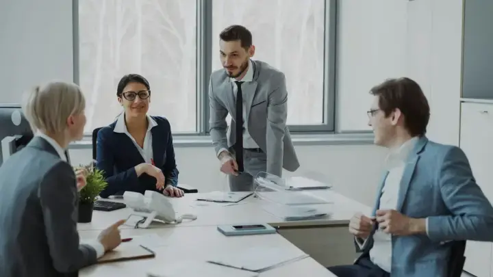 Corporate risk managers collaborating around a conference table, illustrating a fronting insurance and captive reinsurance program