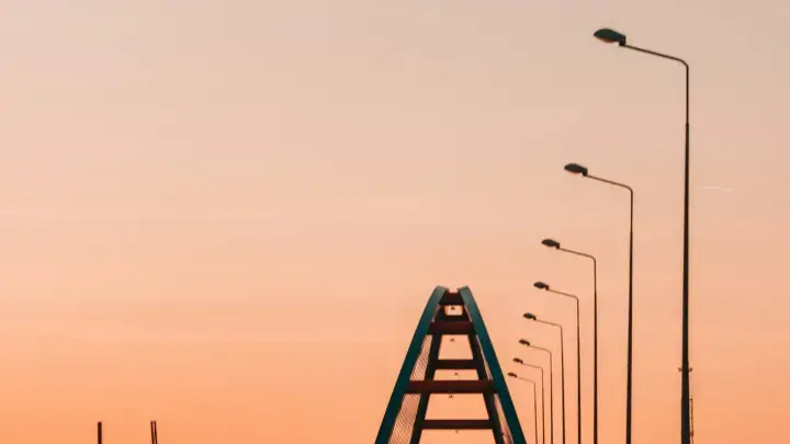Car driving on a highway at sunset, illustrating full coverage auto insurance for liability, collision and comprehensive risks