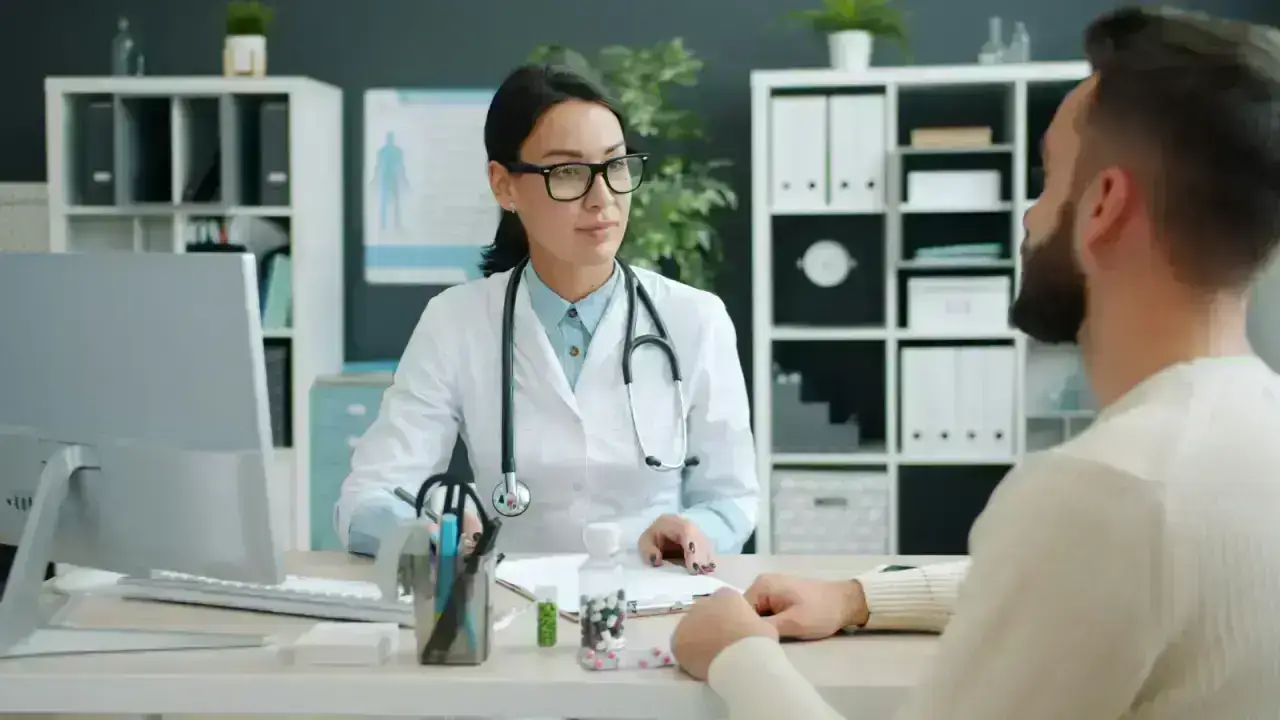 Doctor consulting a patient in a medical office, illustrating health plan network choices