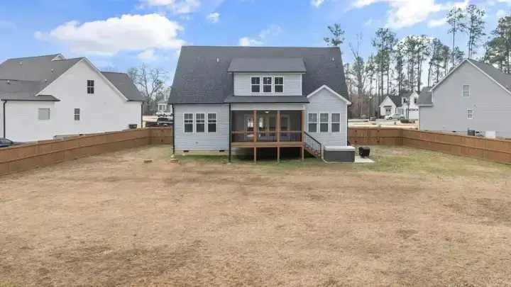 Suburban home with a fenced yard illustrating detached structures and Coverage B homeowners insurance