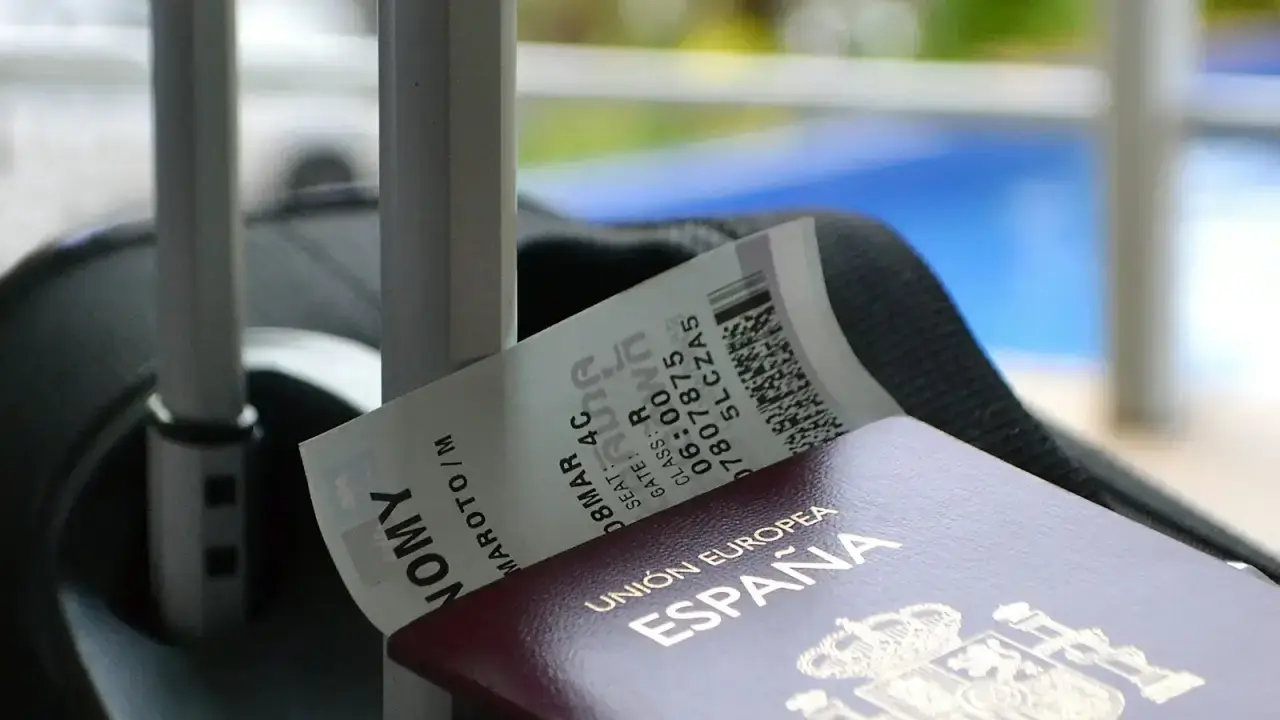 Passport and boarding pass on luggage illustrating the documents travelers need for a travel insurance claim