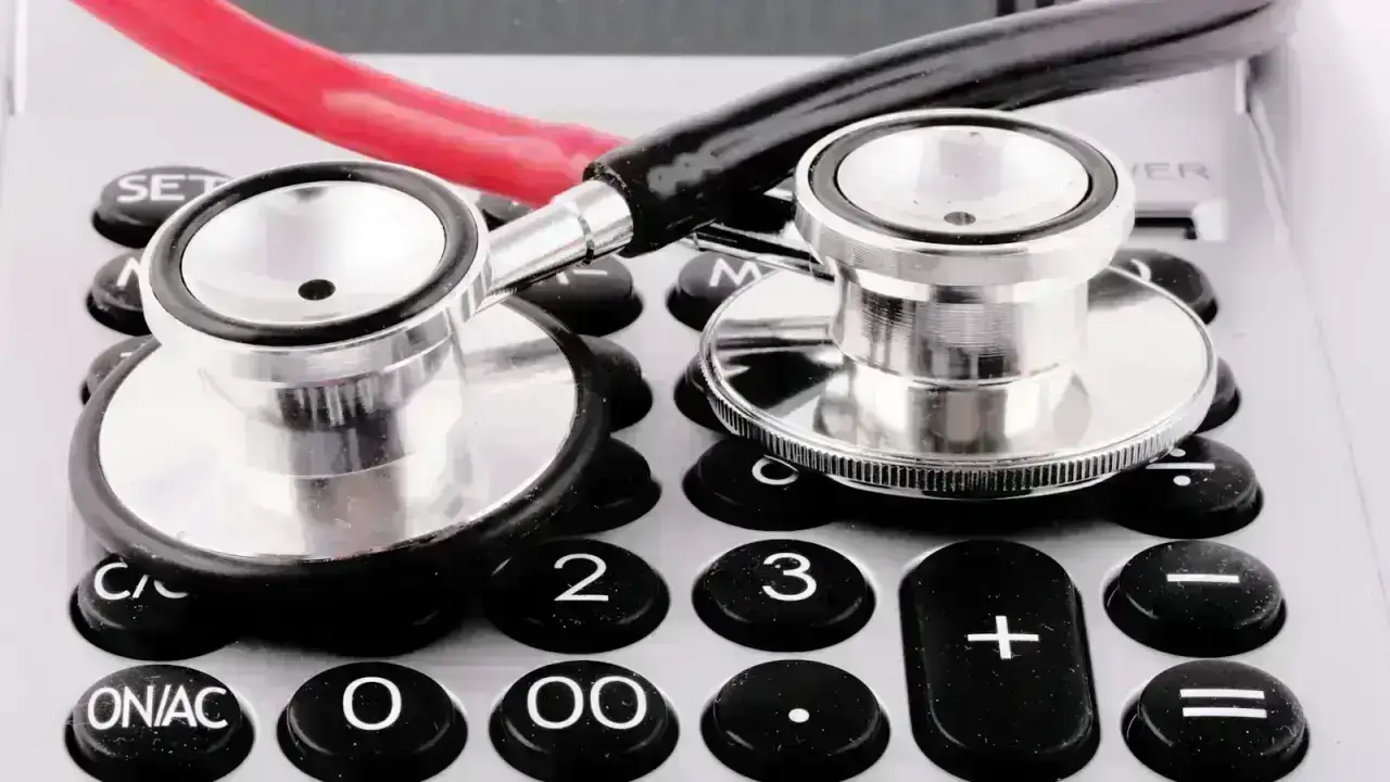 Stethoscope and calculator illustrating how to read a health insurance Explanation of Benefits and medical costs