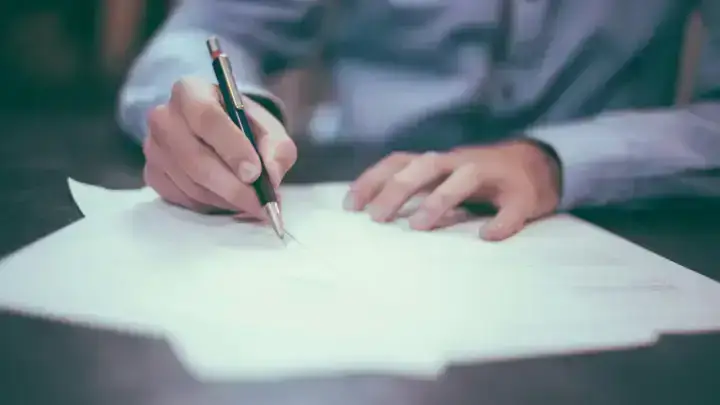 Policy and financial documents on a desk, illustrating how to review an insurance declarations page