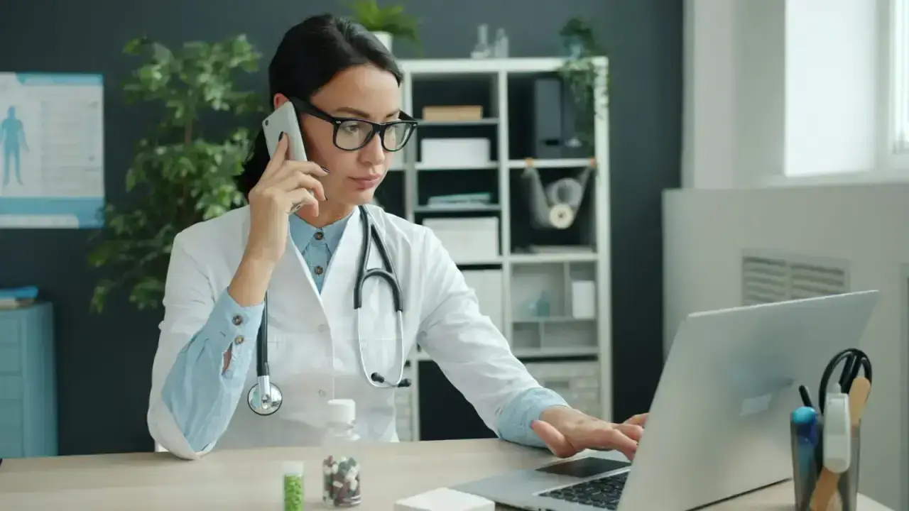 Healthcare professional reviewing information on a laptop, illustrating how to read a Summary of Benefits and Coverage