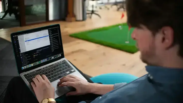 Independent professional working on a laptop in an office while reviewing business insurance needs
