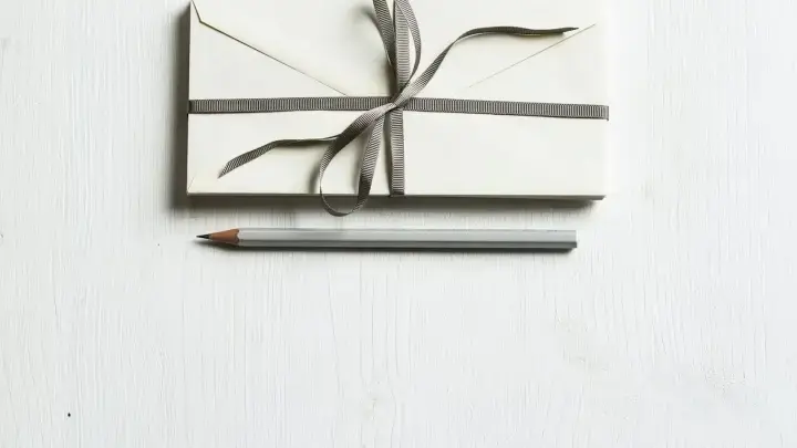 Envelope and pencil illustrating an insurance cancellation or nonrenewal notice and the steps policyholders should take next