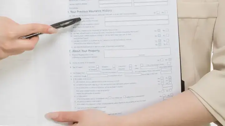 Professional presenting insurance paperwork illustrating producer licensing, appointments and NPN records