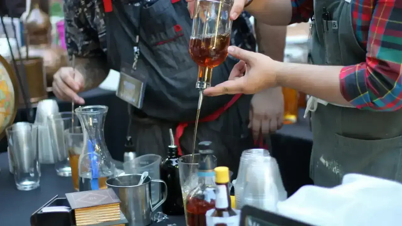 Bartenders preparing alcoholic drinks at a bar, illustrating liquor liability exposure for hospitality businesses