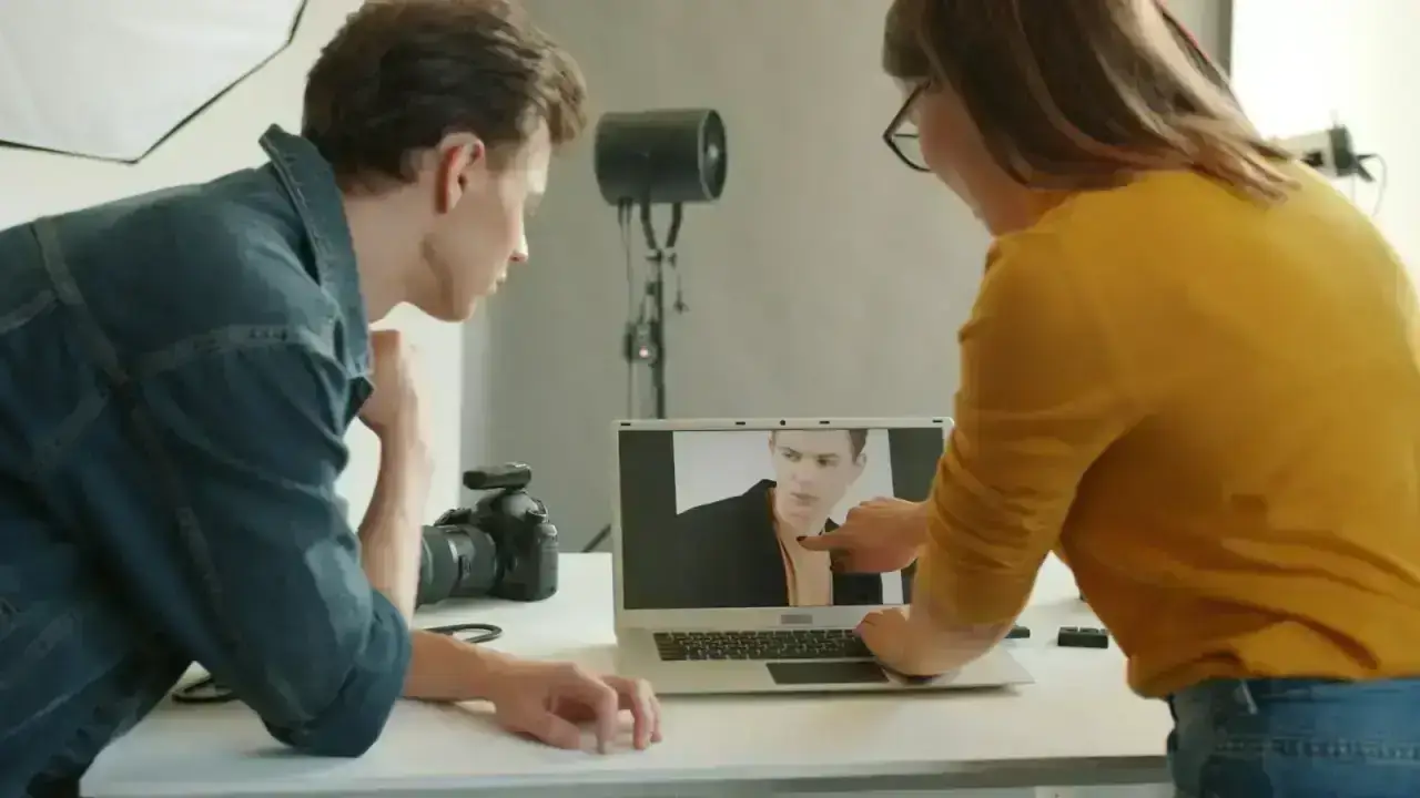 People reviewing digital content on a laptop illustrating media liability coverage in cyber insurance