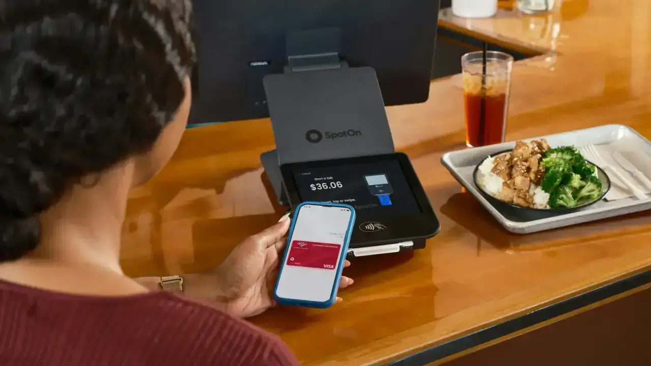 Customer making a digital payment at a cafe, illustrating PCI DSS payment card security and cyber insurance exposure