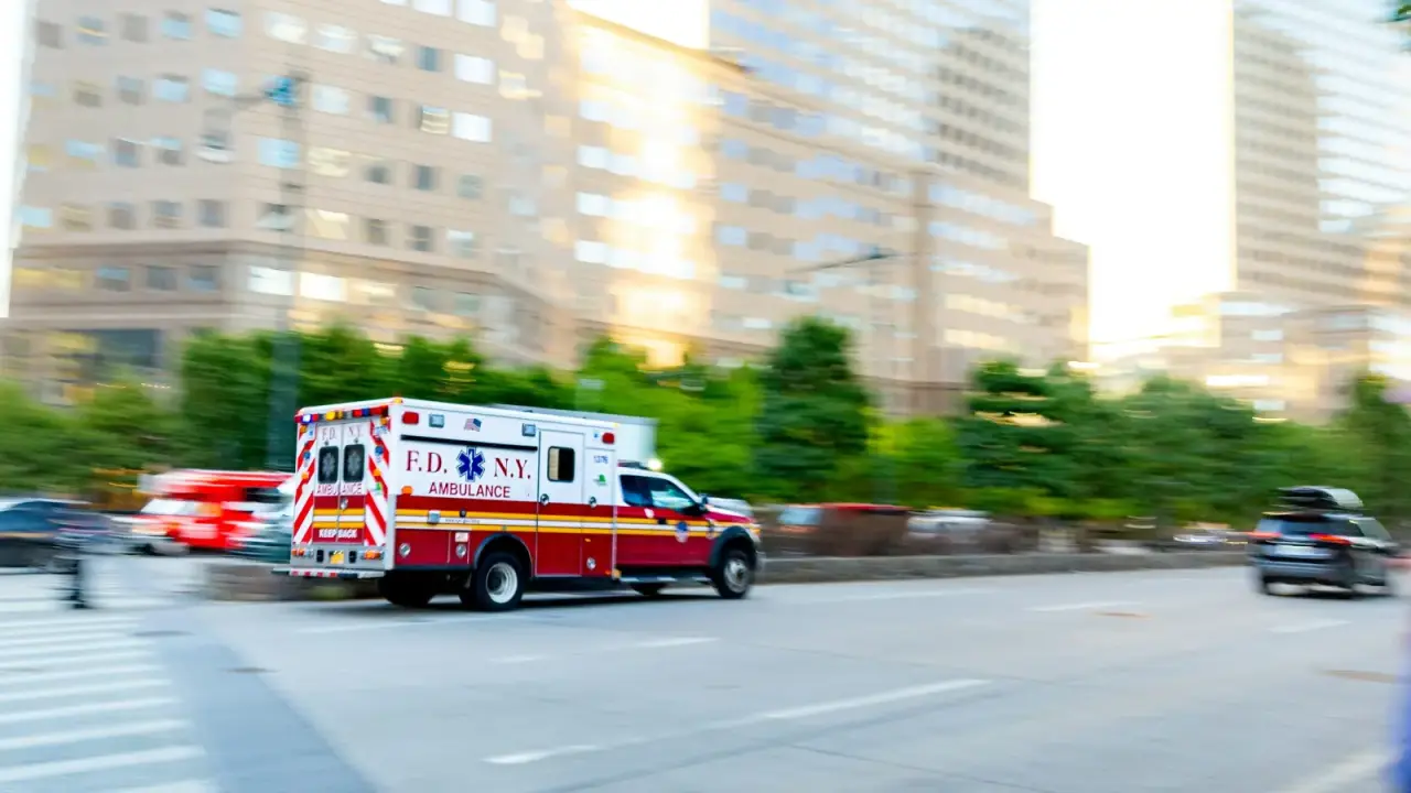 Ambulance responding in a city, illustrating medical-expense coverage after an auto accident
