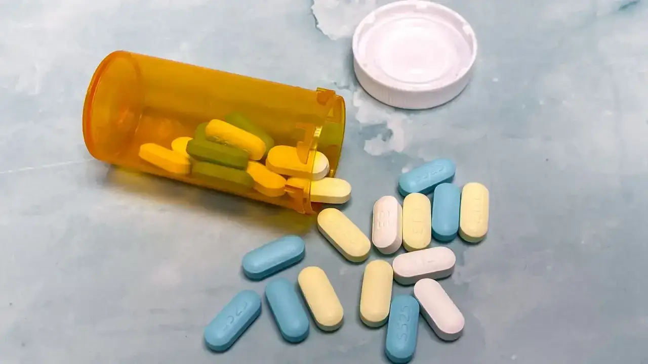 Prescription bottle and pills illustrating health insurance drug formulary tiers and coverage rules