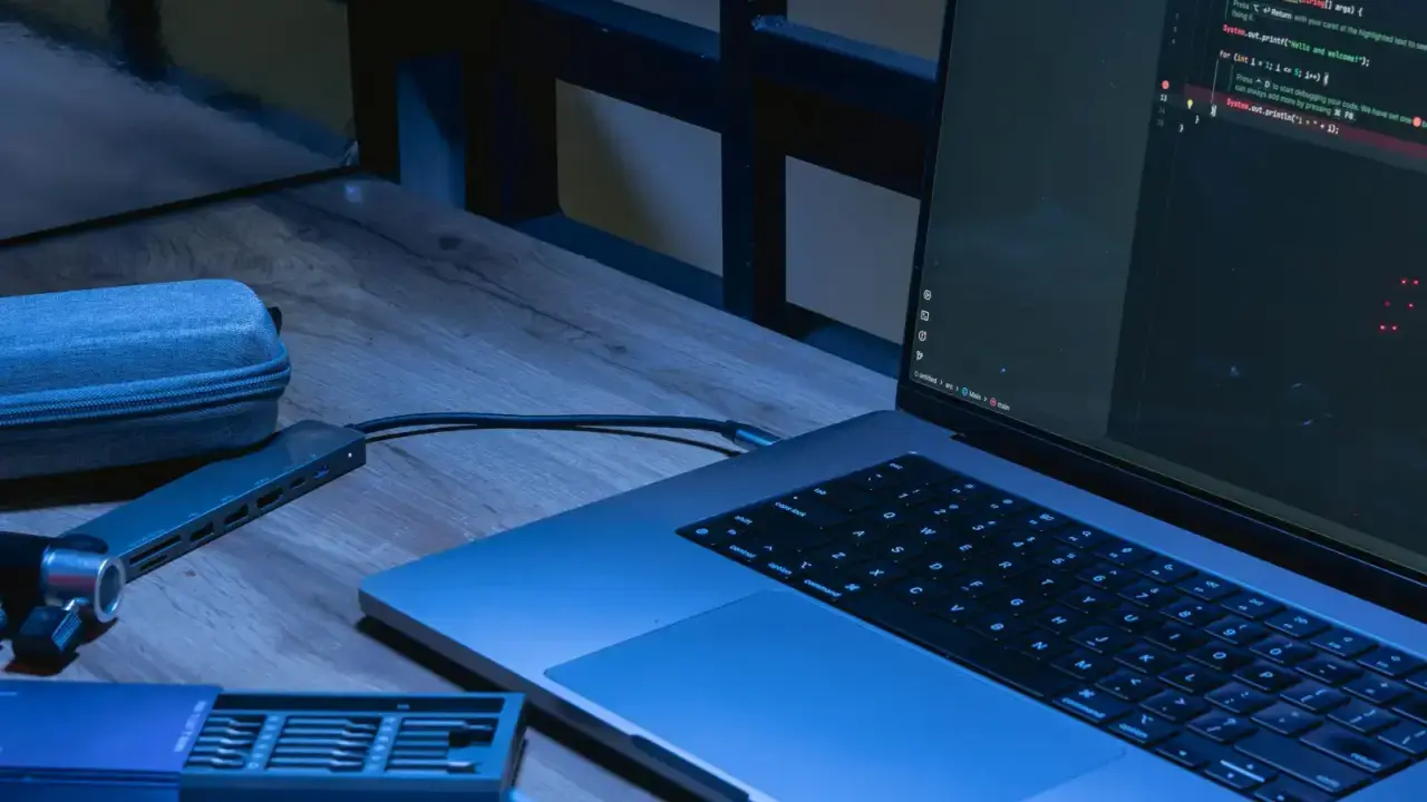 Laptop displaying source code in a cybersecurity workspace for a ransomware insurance guide